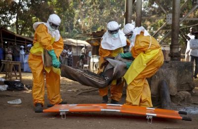 A French Red Cross team picks up a suspected Ebola case from the centre of Forecariah on January 30, 2015. REUTERS/Misha Hussain