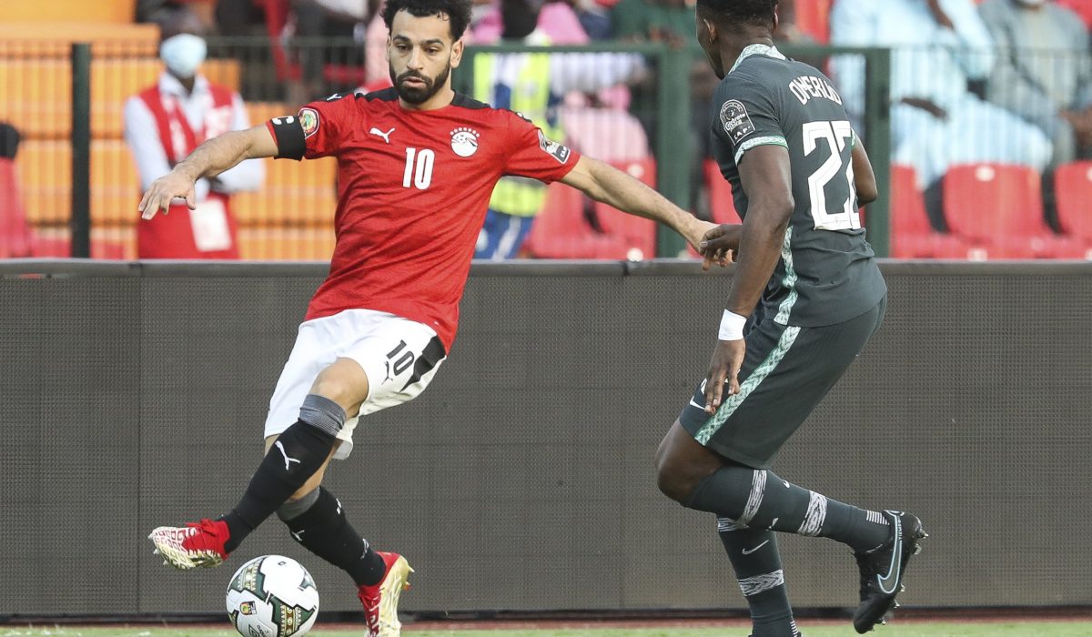 Egypt's Mohamed Salah in action in front of Nigeria's Kenneth Omeruo during the African Cup of Nations Group D soccer match between Egypt and Nigeria in Garoua, Cameroon, Tuesday, Jan. 11, 2022. (AP Photo/Footografiia)