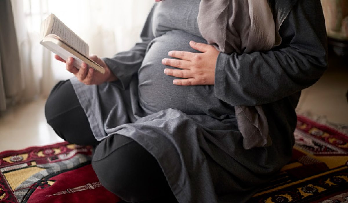 Quran, muslim and pregnant woman praying to Allah, god or holy spirit for islamic religion, faith and baby support. Spiritual book, maternity prayer hope and Islamic person worship during pregnancy