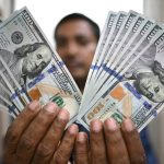 f9f49e-20250819-a-man-holds-usd100-bills-1000