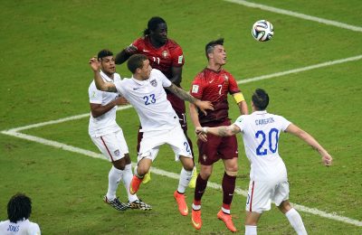 Portugal's forward Cristiano Ronaldo (2R) jumps for the ball during a Group G football match between USA and Portugal at the Amazonia Arena in Manaus during the 2014 FIFA World Cup on June 22, 2014.  AFP PHOTO / FABRICE COFFRINI        (Photo credit should read FABRICE COFFRINI/AFP/Getty Images)