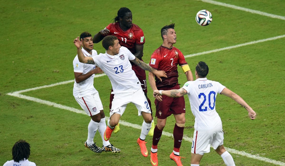 Portugal's forward Cristiano Ronaldo (2R) jumps for the ball during a Group G football match between USA and Portugal at the Amazonia Arena in Manaus during the 2014 FIFA World Cup on June 22, 2014.  AFP PHOTO / FABRICE COFFRINI        (Photo credit should read FABRICE COFFRINI/AFP/Getty Images)